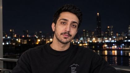 متین موفق مقابل خط آسمان شهر در شب
